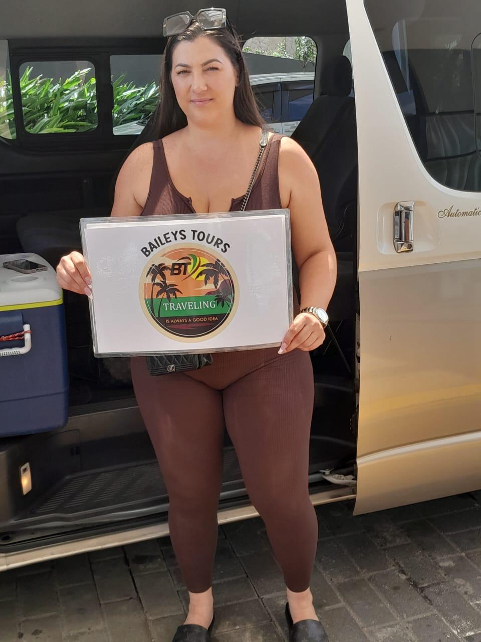 Baileys Tours guests at Negril sign